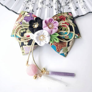 Black floral Japanese kimono hair clip with purple, white, and black cherry blossoms and gold rope bow.