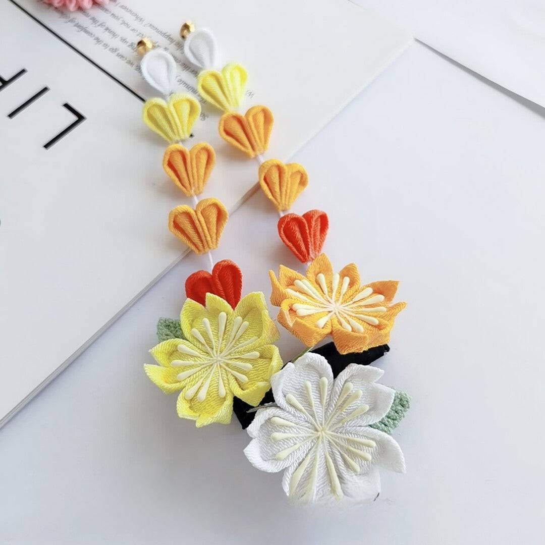 Dangling yellow and orange sakura hairpins with heart-shaped petals, from the Japanese kimono headdress set.