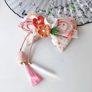 Cream and orange Japanese kimono hair accessory with cherry blossom flowers, fine bow work, and pink-white tassel detail.