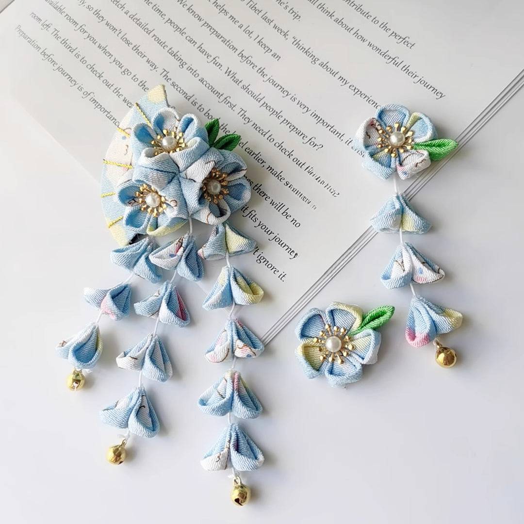 Blue Japanese kimono hairpin set with five-petal fan flowers and tassels, featuring gold bells and floral fabric details.