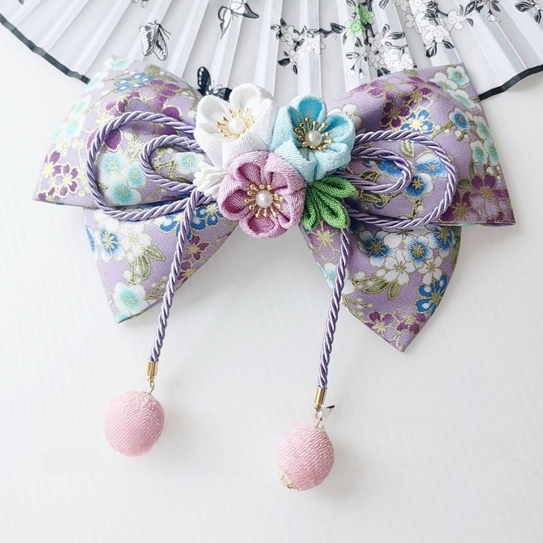 Purple floral kimono hairpin with pastel cherry blossoms, pearl centers, and purple tassels for Japanese lolita styling.