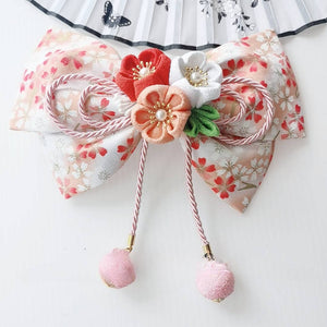 Peach floral Japanese kimono hair accessory with orange and white cherry blossoms and soft pink ball tassels.