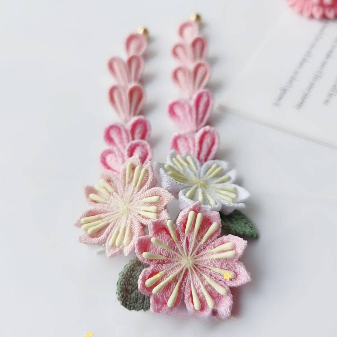 Close-up of dangling sakura hairpins with pink and white flowers, part of a 4-piece Japanese kimono headdress set.
