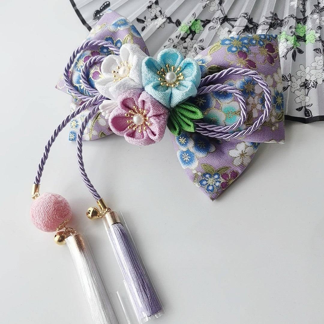 Purple and blue cherry blossom kimono hairpin with floral bow and white tassels for Japanese girl fashion.
