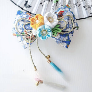 Blue floral Japanese kimono hair clip with yellow, white, and turquoise cherry blossoms and teal tassels.