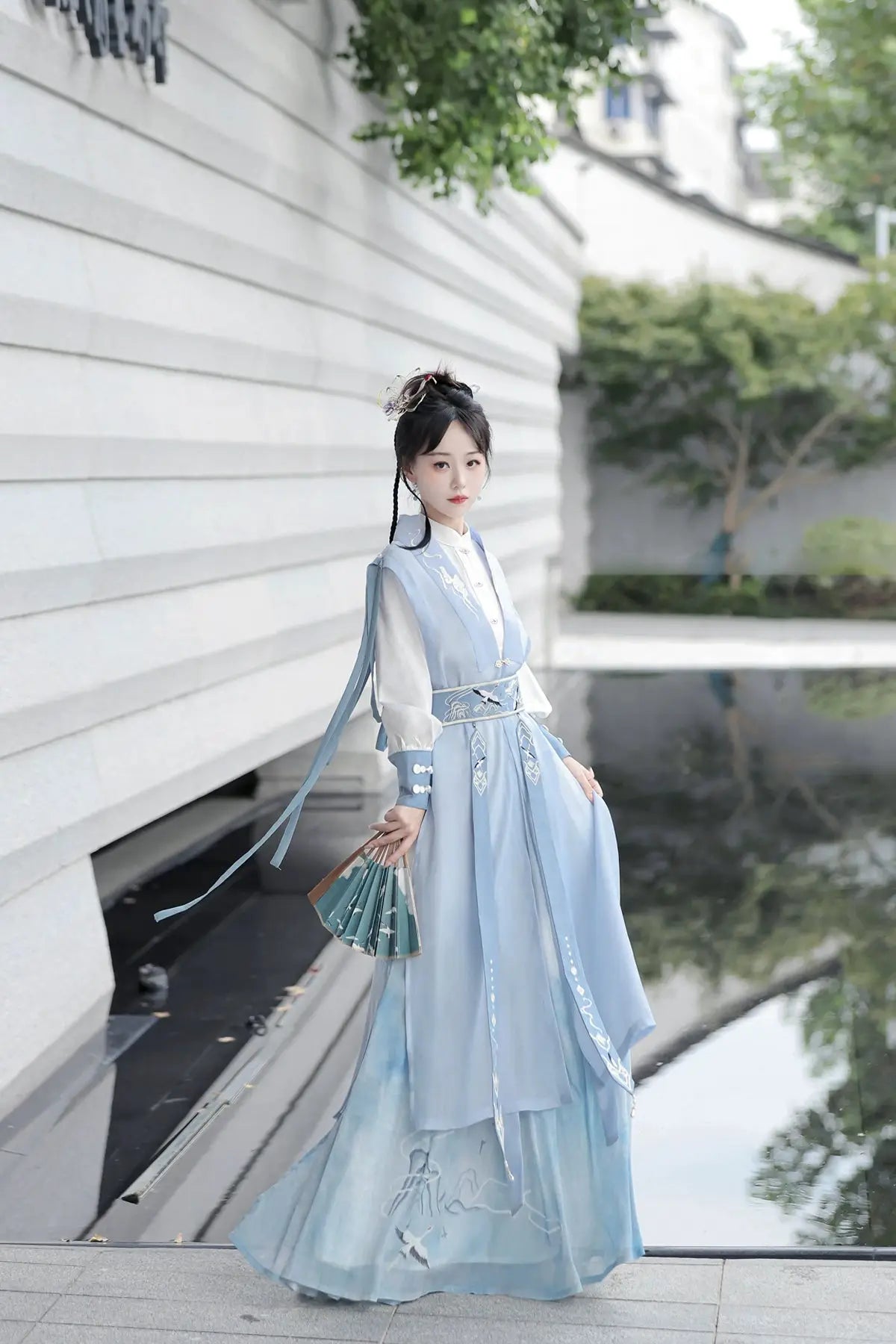 Blue hanfu dress for women, blending traditional Song Dynasty and modern Chinese styles, crafted from luxurious silk. This versatile hanfu includes options for a matching coat or jacket, making it suitable for winter wear, Chinese New Year celebrations, or casual outings. Ideal for occasions like graduations or cosplay, this dress embodies the fairy-inspired elegance of classic hanfu while also drawing from martial arts clothing and contemporary Chinese fashion. Available for purchase in our online hanfu sh
