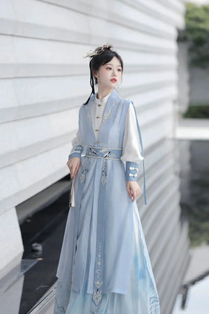Blue hanfu dress for women, blending traditional Song Dynasty and modern Chinese styles, crafted from luxurious silk. This versatile hanfu includes options for a matching coat or jacket, making it suitable for winter wear, Chinese New Year celebrations, or casual outings. Ideal for occasions like graduations or cosplay, this dress embodies the fairy-inspired elegance of classic hanfu while also drawing from martial arts clothing and contemporary Chinese fashion. Available for purchase in our online hanfu s