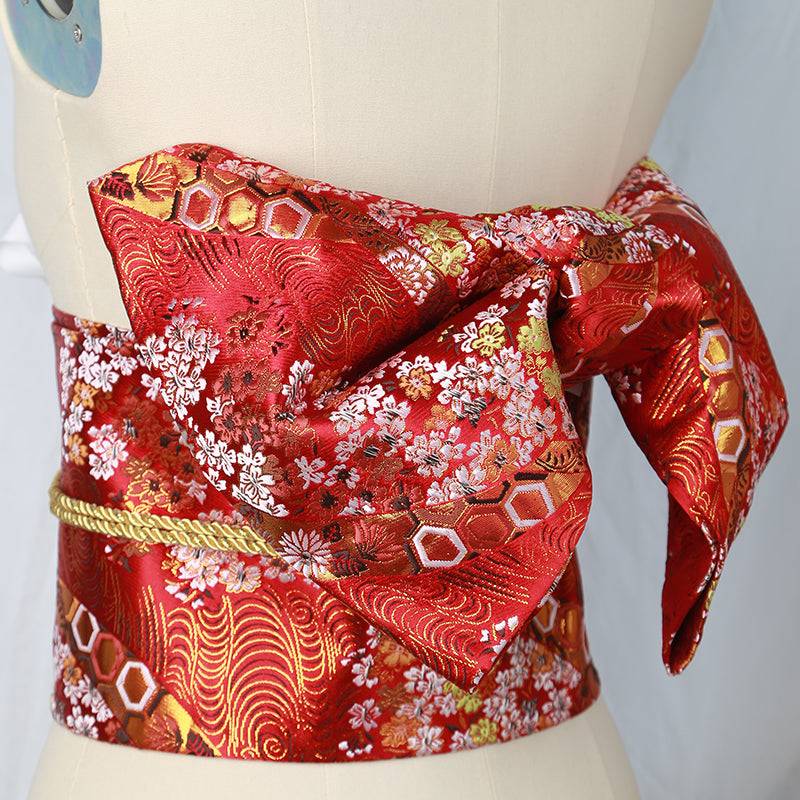 Japanese kimono waist seal in red brocade with floral and hexagon patterns, featuring a large bow knot for yukata styling and photo shoots.