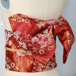 Red floral brocade bow belt styled on mannequin, designed for Japanese kimono waist seal and yukata fashion enhancement.