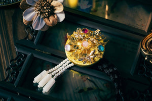 Gold Korean traditional ethnic headgear with intricate gold leaves, gemstone accents, and pearl tassels, made with precise cutting.