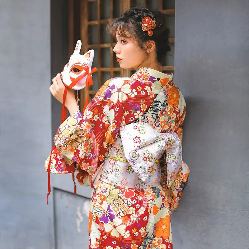 Elegant Japanese retro kimono with vibrant floral prints and a decorative obi. A stunning fireworks kimono dress for special occasions.