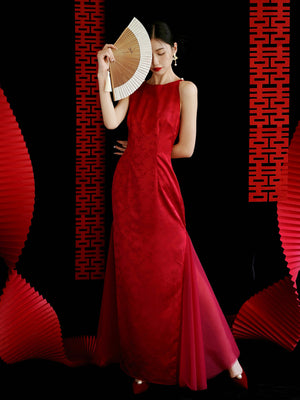 Red cheongsam wedding dress with sheer tulle sides, perfect for bridal engagement or toasting ceremonies.