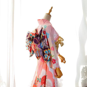 Side view of pink kimono with floral prints and purple big three-leaf bow belt. Swinging sleeves and geisha-style belt included.