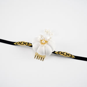 White Hanbok headdress with gold and pearl embellishments on black ribbon, reflecting Yanji Folk Korean tradition on white background.