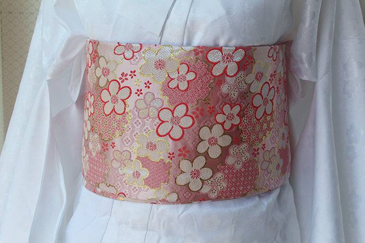 Front view of pink floral brocade kimono waist seal styled on white kimono. 120cm reversible cotton canvas with gold detailing.