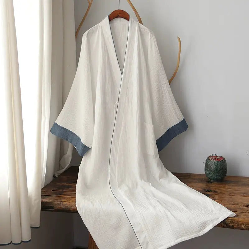 Chinese style white Hanfu robe with blue sleeve cuffs draped on bench, made from pure cotton for elegant homewear or pajamas.
