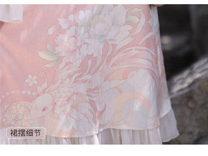 Detailed view of floral embroidery on pink Feihua Hanfu Cheongsam Dress hem, highlighting the elegant New Chinese style.