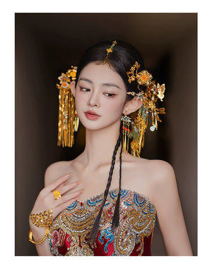 Close-up of bride in embroidered gown wearing antique Chinese butterfly tassel hairpin and matching jewelry for wedding elegance.