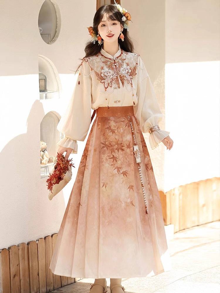 Stylish Hanfu set with cloud shoulder detailing and pleated skirt in warm autumn hues, designed for springtime elegance.
