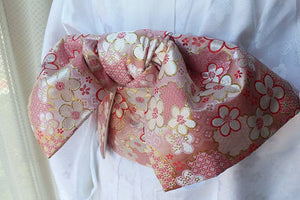 Close-up of pink floral brocade bow on kimono waist seal, styled on white kimono. 120cm reversible cotton canvas with gold accents.