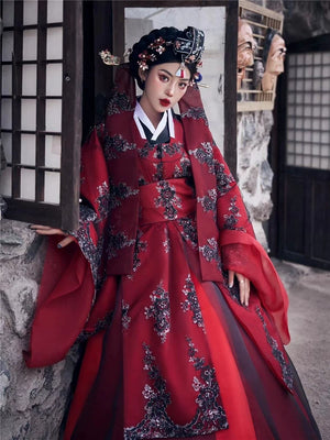 Yandan_Hanfu red traditional Korean palace-style wedding dress with black floral embroidery, ancient stone building
