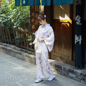Graceful Japanese kimono dress for women in a delicate beige tone with cherry blossom motifs. A stylish yukata for traditional elegance.