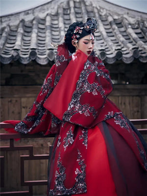 Red palace-style hanbok with intricate embroidery, ancient roof backdrop