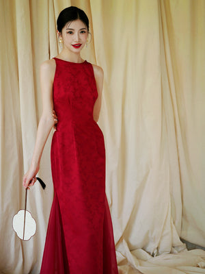 Bride in red cheongsam dress holding fan, styled for traditional wedding or engagement celebrations.