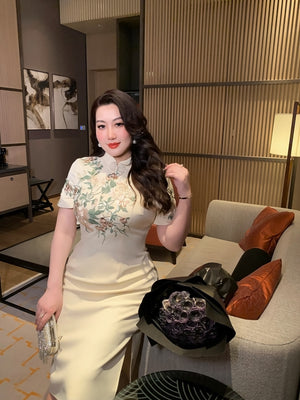 Elegant plus size long cheongsam in champagne with floral embroidery, showcasing a flattering fit and classic Chinese style.