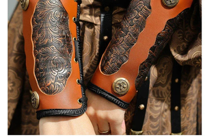Close-up of brown wrist guards with patterned panels and lace-up fastenings