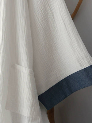 Sleeve detail of Chinese style white Hanfu robe with contrasting blue cuff, showcasing traditional design and soft cotton fabric.