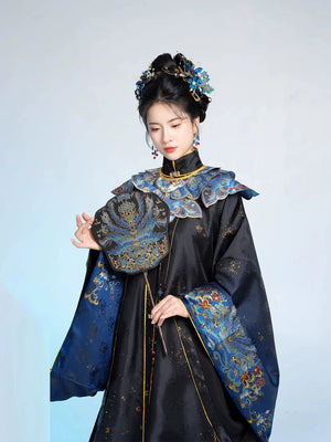 Close-up of 2025 Chinese style graduation Hanfu in black and blue with embroidered fan and ornate shoulder detailing.