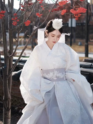 White Yanji Hanbok court dress with lavender sash and floral embroidery, traditional Korean costume for cultural fashion.