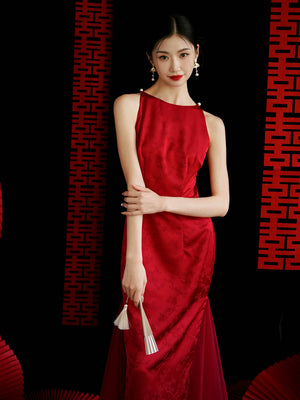 Model in red yarn cheongsam bridal dress with floral pattern, styled for wedding or engagement occasions.