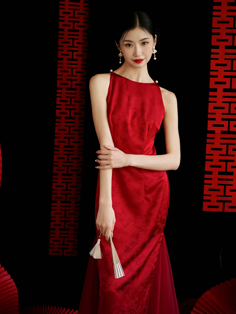 Model in red yarn cheongsam bridal dress with floral pattern, styled for wedding or engagement occasions.
