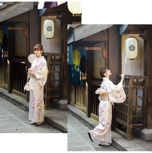 Two images of a woman in a Japanese kimono dress, interacting with a lantern. The beige yukata features cherry blossom motifs.