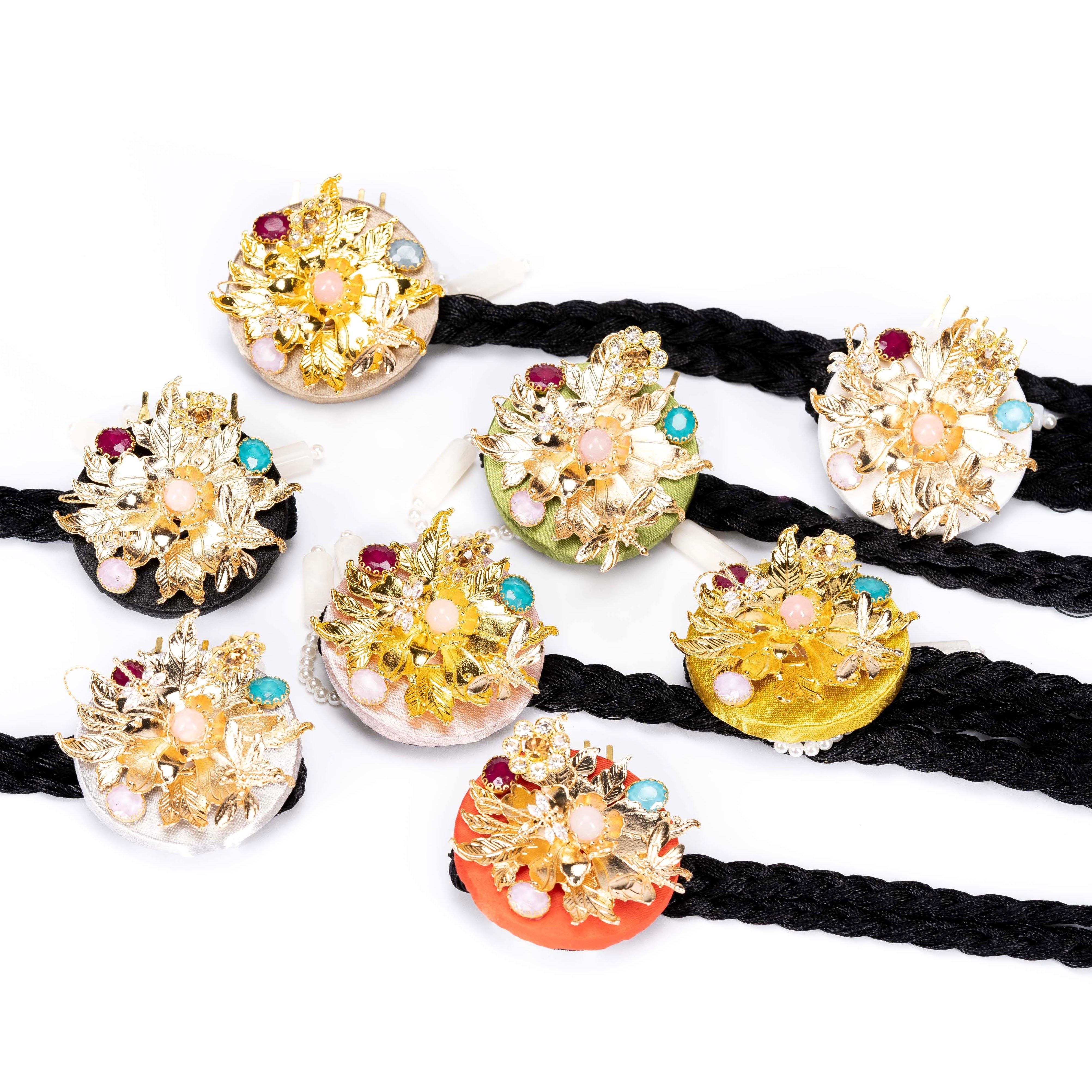 Assorted Korean traditional ethnic headgear collection with gold floral designs, gemstone accents, and braided ties, all finely cut.
