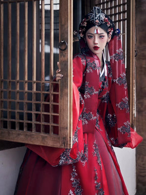 Yandan_Hanfu red traditional Korean palace-style wedding dress with black floral embroidery, traditional wooden structure