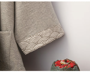 Cuff detail of gray Hanfu pajamas set with wave-pattern trim, emphasizing traditional Chinese design elements.