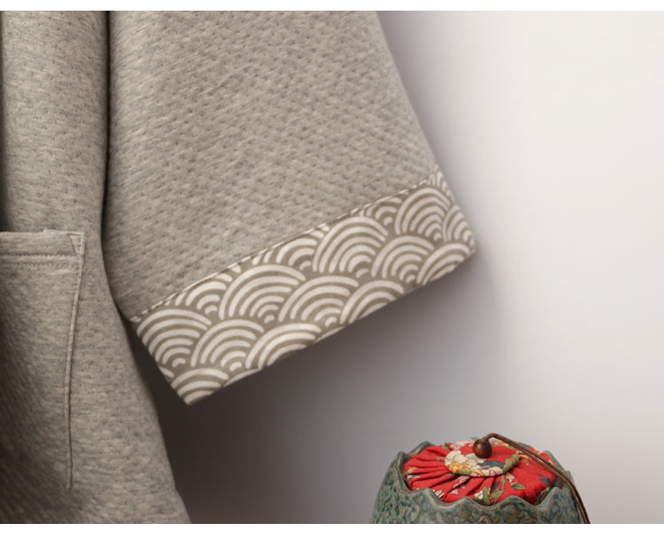 Cuff detail of gray Hanfu pajamas set with wave-pattern trim, emphasizing traditional Chinese design elements.