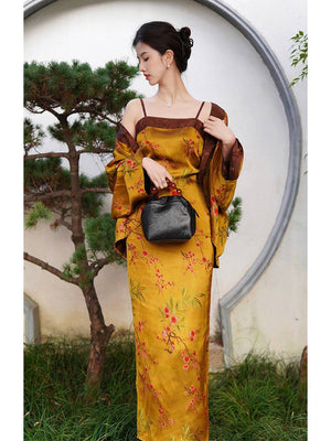 High-end Golden Jelly Dress Set with fragrant cloud yarn jacket and floral jacquard design, styled with a black handbag near a circular garden gate.