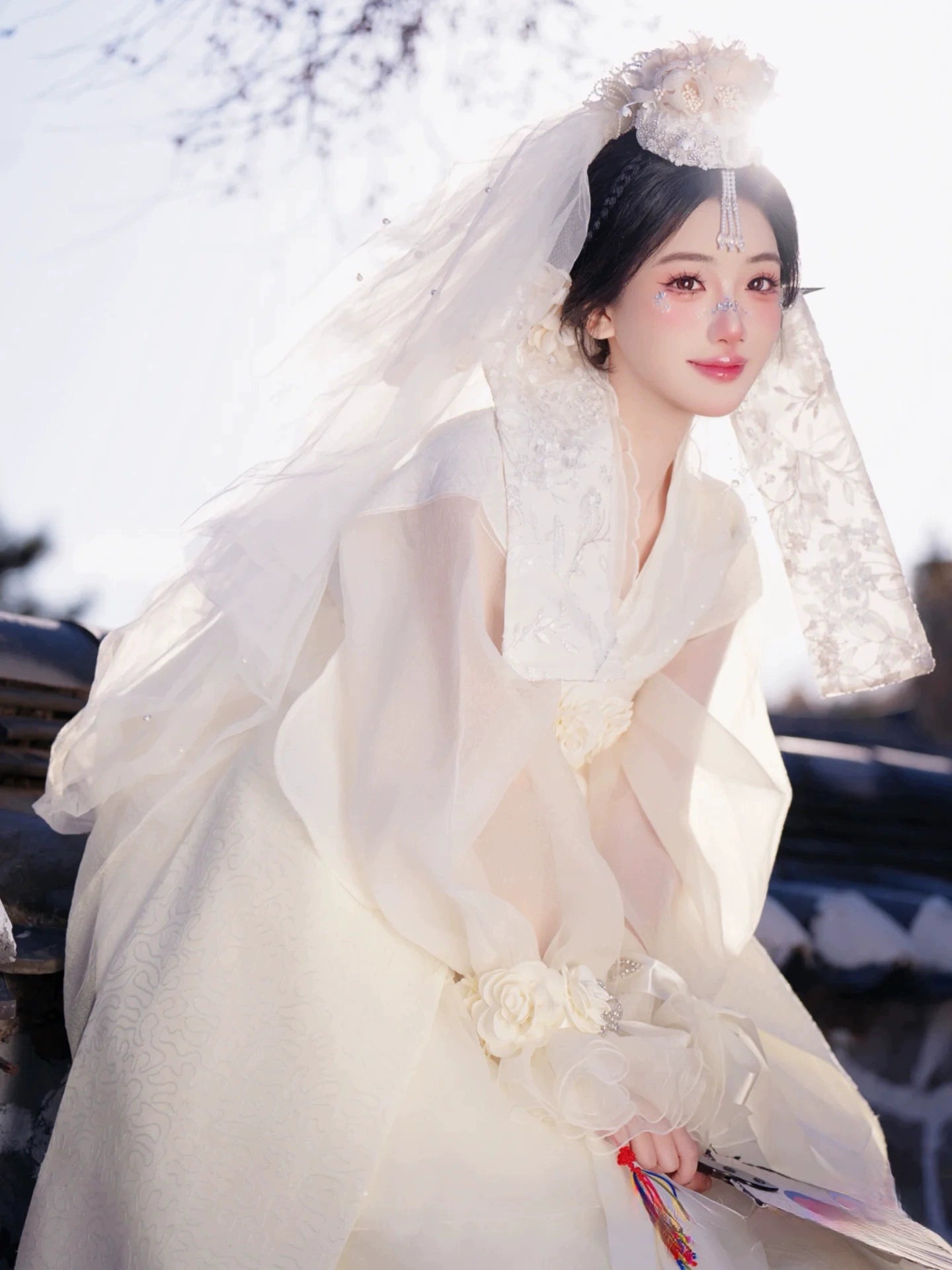 Elegant Korean traditional high-end wedding dress Hanbok in white, worn outdoors with lace veil and floral accessories for princess-style shoot.