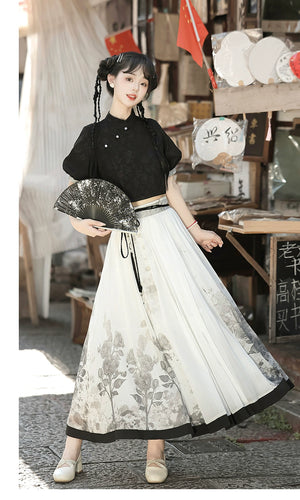 Stylish modern Hanfu outfit with black top and floral print skirt, accessorized with fan for spring and summer elegance.