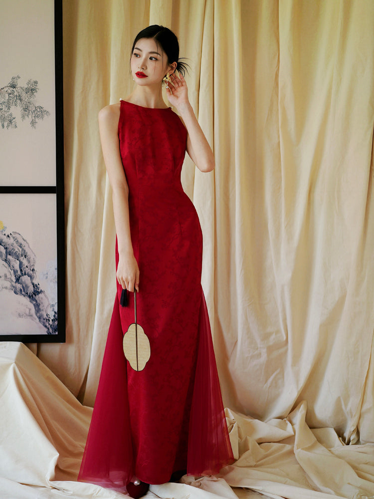 Bride in red cheongsam dress smiling with fan, perfect for bridal engagement or wedding events.