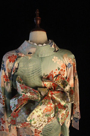 Front view of Brocade Premium Styling Bow Waist Seal on mannequin in floral kimono, highlighting bow's volume and brocade detail.
