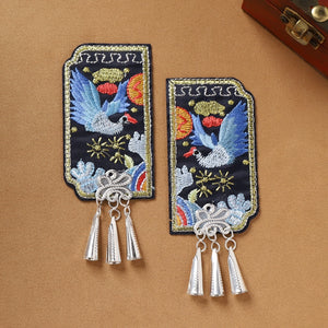 Pair of Guizhou Miao fridge magnets with blue bird embroidery and silver cone fringe, handmade ethnic kitchen decor.