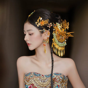Side view of antique Chinese butterfly bridal hairpin featuring gold tassels and floral details, perfect for traditional wedding attire.