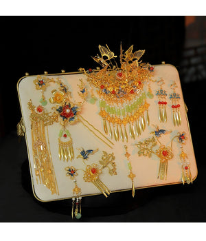 Chinese antique bridal hairpin set with butterfly and tassel motifs, displayed on white board for wedding accessory showcase.