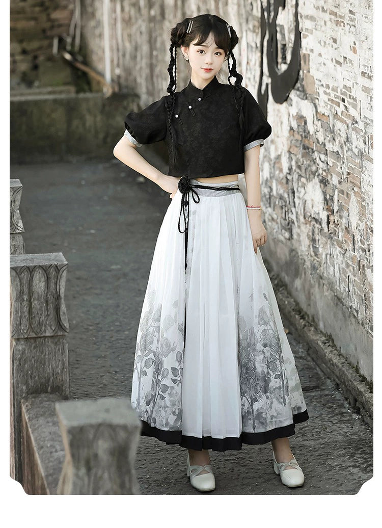 Model posing in New Chinese style black top and floral skirt set, showcasing modern Hanfu elegance for spring and summer.