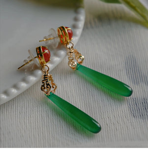 Traditional Chinese style earrings with green agate drops and red gemstone studs, detailed with gold filigree for elegant wear.